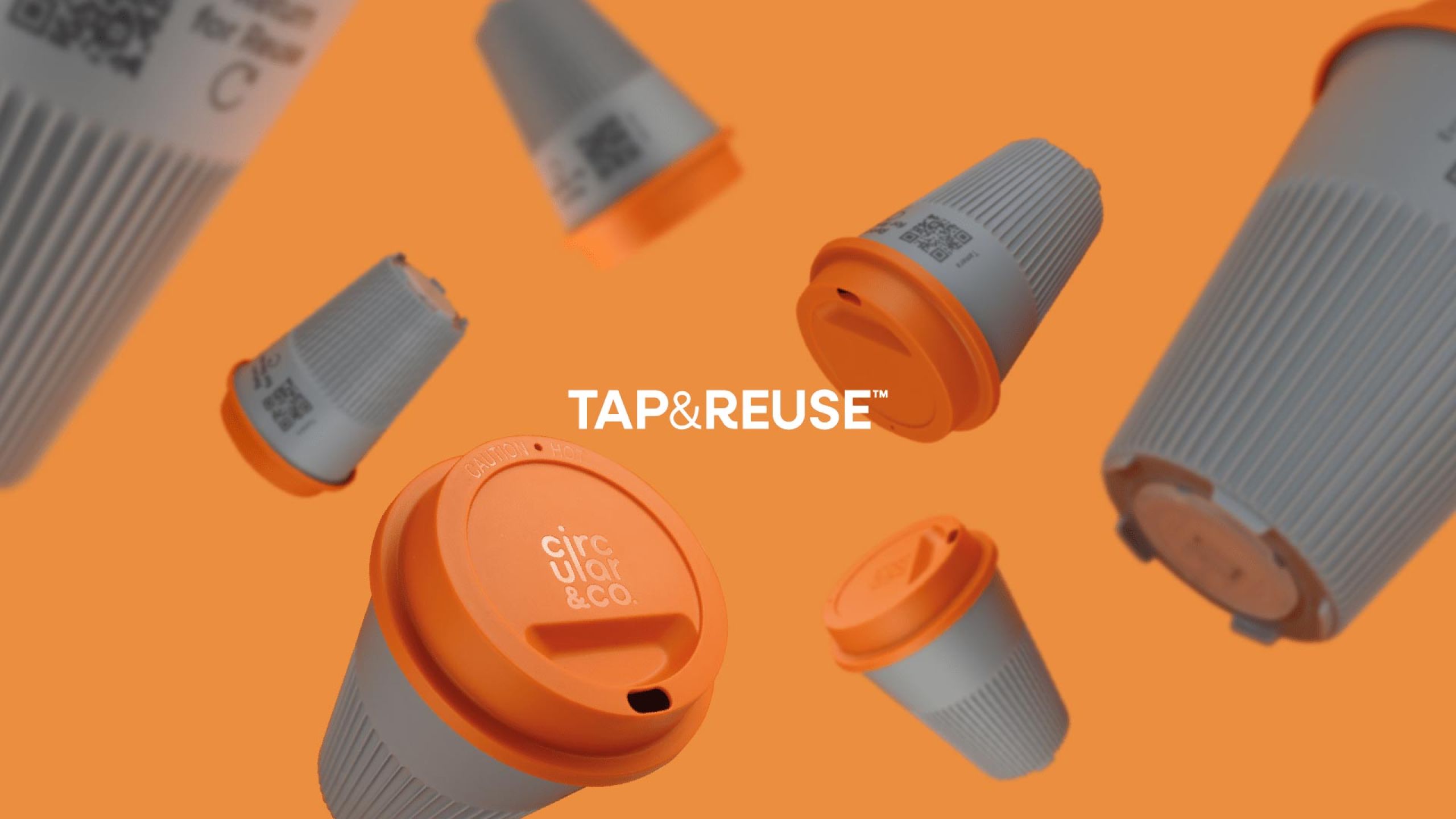 floating circular&co returnable cups grey base orange lids on orange background
